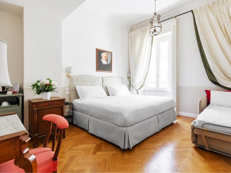 Camera elegante, luminosa, con letto accogliente e parquet caldo.